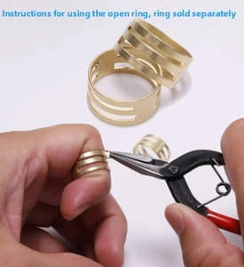 Close-up showing how to use jewelry pliers with golden open rings for DIY crafts