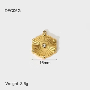Macro detail of 16mm gold plated hexagonal scallop pendant with clear gemstones