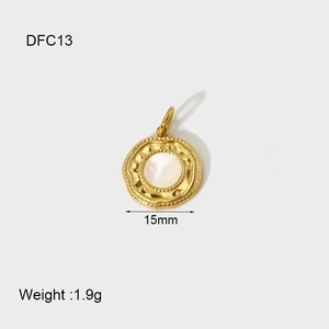 Detail of 14K gold plated shell pendant with white mother of pearl inlay, 15mm diameter
