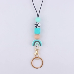 Detail of silicone beaded lanyard with mint rainbow charm and gold metal lobster clasp