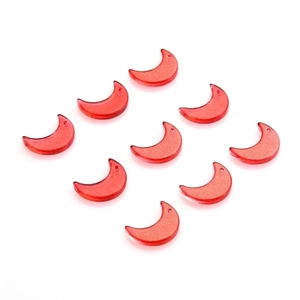 Close-up of nine red moon-shaped acrylic pendants for DIY jewelry and crafts