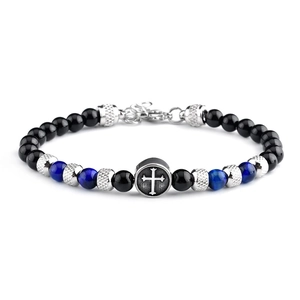 Detailed view of beaded bracelet with blue tiger eye stone and silver cross charm