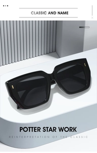 Detail of black square sunglasses featuring elegant gold rectangular rivet decorations