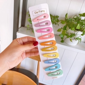 Close-up of 10 colorful matte drop-shaped BB hair clips on a white display card