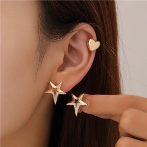 Gold star earrings with zircon and heart ear cuff set shown on a model for daily wear