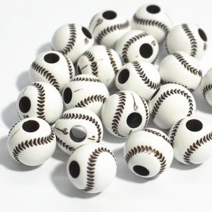 Close-up of white acrylic baseball beads with brown stitching texture for DIY jewelry