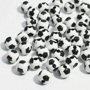 Close-up of black and white football pattern acrylic beads with hole for DIY jewelry making