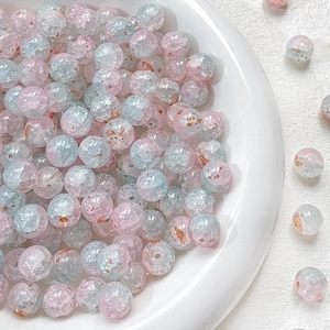 Macro detail of 10mm pink and mint green crackle glaze glass beads for jewelry making
