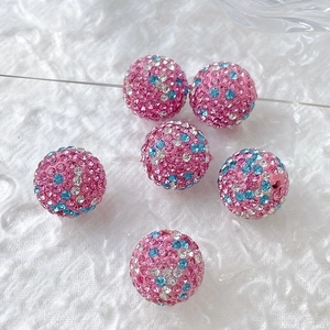 Close-up of sparkling colorful gradient rhinestone disco balls for DIY jewelry making