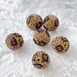 Close-up of leopard print rhinestone clay beads for DIY jewelry and phone chains