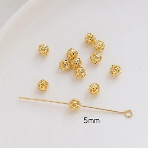 Detailed view of 5mm gold-plated hollow spherical beads for DIY jewelry making