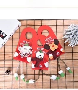 Detailed view of Christmas door hangers with Santa, Snowman and Reindeer plush figures
