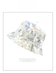 Detailed view of floral bucket hat with blue and orange flower patterns and stitched brim