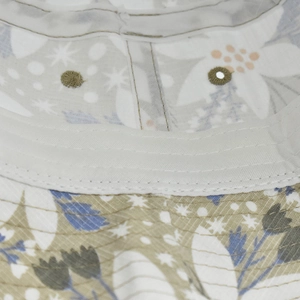 Detailed close-up of a floral bucket hat showing sweatband stitching and metal eyelets