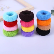 Close-up of assorted colorful plush hair scrunchies in blue red pink and green tones