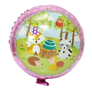 Detail of round foil balloons featuring cartoon jungle animals and birthday cake pattern