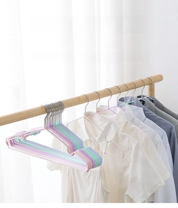 Close-up of non-slip multi-color hangers showing wet and dry use on a wooden clothes rail