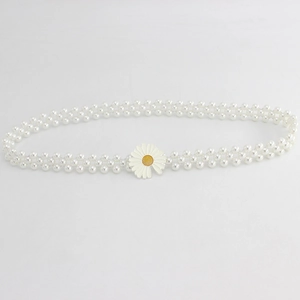 Détail de la ceinture à double rangée de perles avec une boucle délicate en forme de marguerite