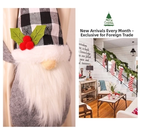Close-up of Christmas gnome curtain tie and decorative knitted stockings for holiday home decor