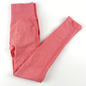 Close-up of seamless coral red heathered yoga leggings with ribbed high waistband