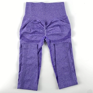 Detail view of purple high-waist yoga pants featuring seamless scrunch butt design and texture