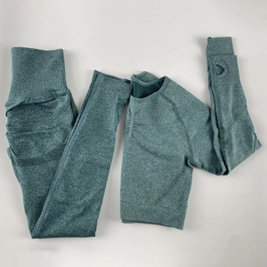 Detail of seamless dark green yoga set with thumb holes and ribbed texture high waist leggings