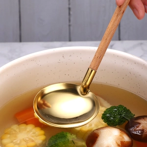 Japanese style 304 stainless steel soup ladle with beech wood handle in a food scene