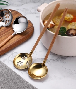 SUS 304 stainless steel soup and slotted spoons with beech handles on a marble surface