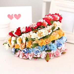 Detailed macro view of vibrant artificial silk roses and foliage on floral headbands