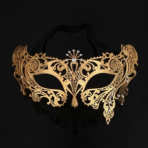 Detailed view of golden laser-cut metal masquerade mask with sparkling rhinestones