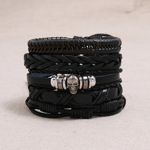 Multi-layer black braided leather bracelet featuring a vintage metal skull centerpiece