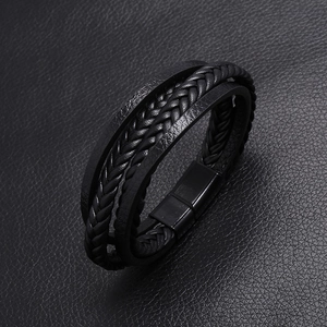 Close-up of multilayered black braided leather bracelet with a matte black magnetic clasp