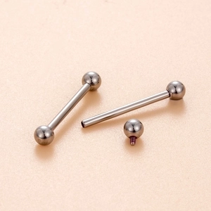 Internal thread G23 titanium barbell tongue ring with screw design and ball top on beige texture