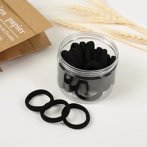 Set of black high-elastic seamless hair ties in a clear cylindrical storage jar