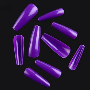 Macro shot of purple coffin-shaped press-on nails with a smooth glossy finish texture