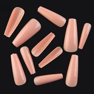 Close-up of nude pink coffin press-on nails in various sizes on black background