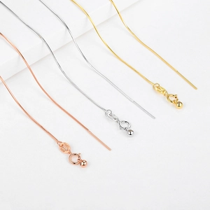 Macro shot of silver, gold, and rose gold snake chains with S925 ITALY hallmarks