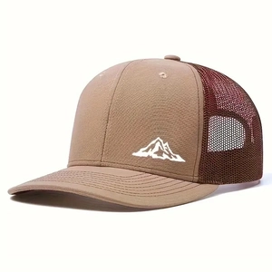 Detail of mountain embroidery on a brown mesh trucker hat with a curved visor