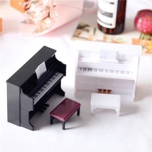 Miniature dollhouse upright piano models in black and white with matching stools