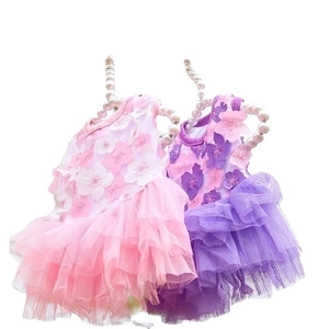 Floral pet princess dresses in pink and purple with mesh layers on pearl hangers