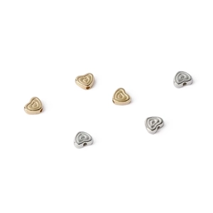 Macro shot of gold and silver heart-shaped CCB beads for DIY jewelry making