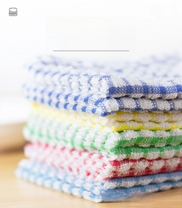 Macro detail of high-absorbent cotton kitchen towels with classic colorful plaid pattern