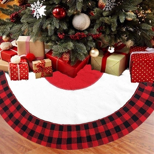 Detail of red and black buffalo plaid knitted Christmas tree skirt with festive gift boxes
