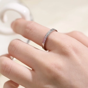 Close-up of a silver titanium steel ring featuring a delicate pave-set diamond design