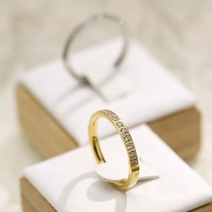 Macro shot of minimalist gold and silver stackable rings with sparkling zircon inlay