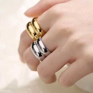 Polished double-layered minimalist gold and silver band rings shown on fingers