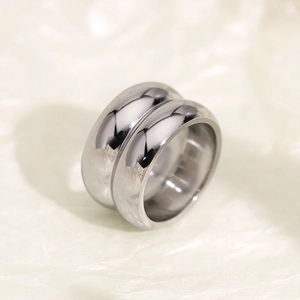 Macro shot of silver dual-layer titanium steel ring with polished mirror finish