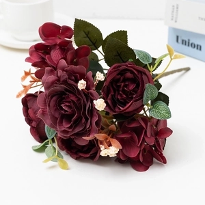 Close-up of artificial burgundy roses and hydrangeas with realistic silk petals