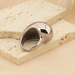 Macro shot of liquid metal style silver chunky ring with polished mirror finish surface