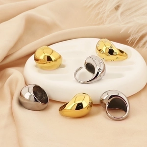 Detail of 18K gold plated teardrop ring with cubic zirconia on silk background
